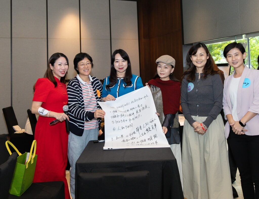 A group of women presenting a workshop poster together